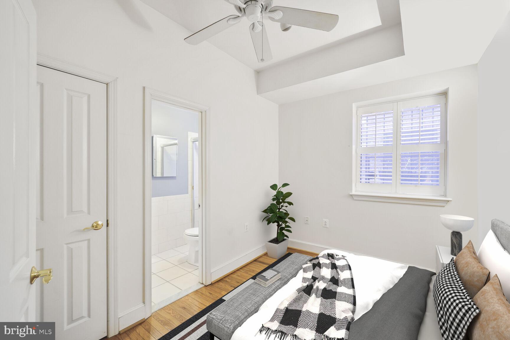 1419 Clifton Street Northwest, Unit 105 Washington, DC 20009 - Photo 15 of 19 a bedroom with a bed and a chandelier