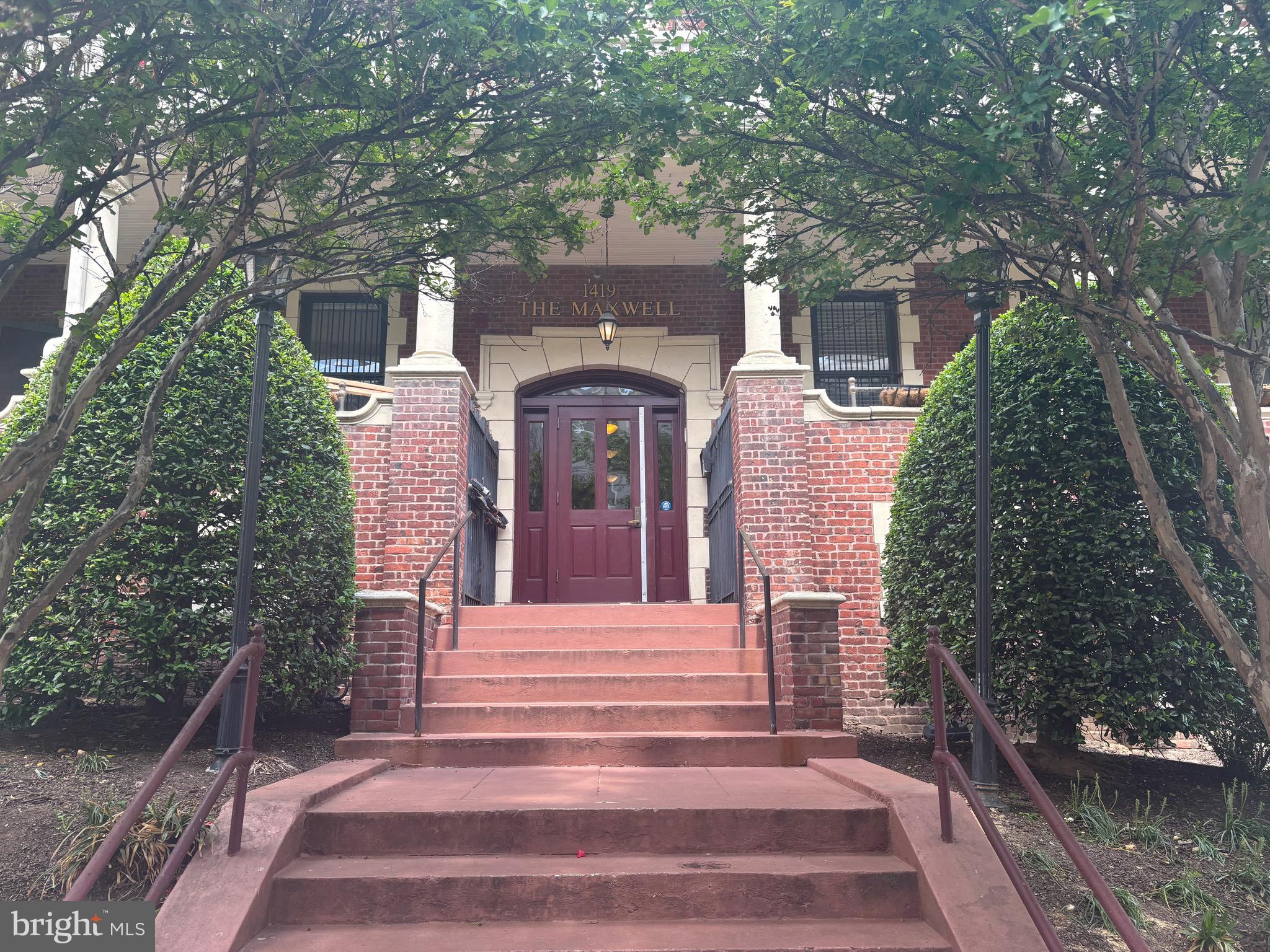 1419 Clifton Street Northwest, Unit 105 Washington, DC 20009 - Photo 2 of 19 a front view of a house with a tree