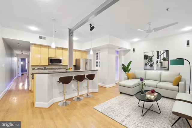 a living room with kitchen island furniture and a wooden floor