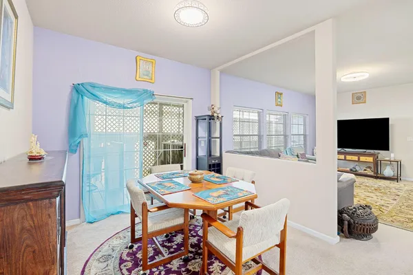 a dining room with furniture and a flat screen tv
