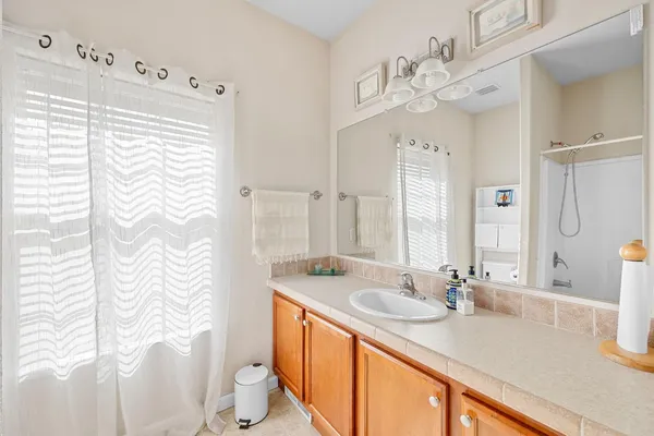 a bathroom with a sink a toilet and a large mirror