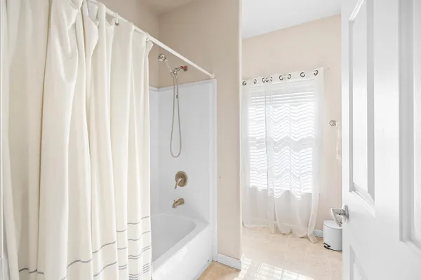a bathroom with a bathtub and shower