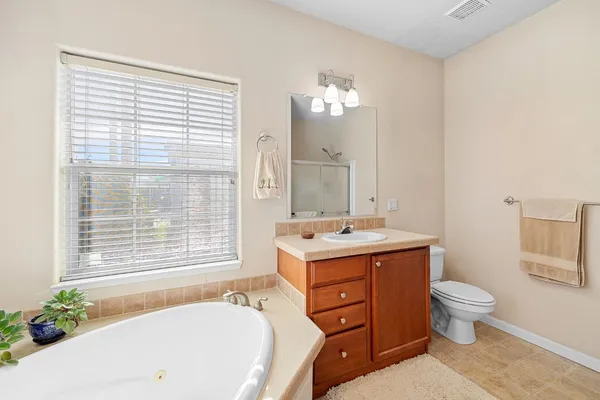 a bath room with a sink a toilet and a mirror