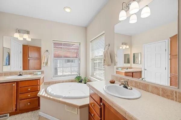 a bathroom with a double vanity sink and a mirror