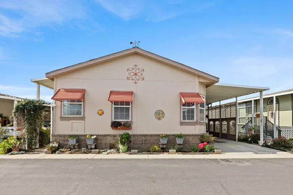 a front view of a house with a garden