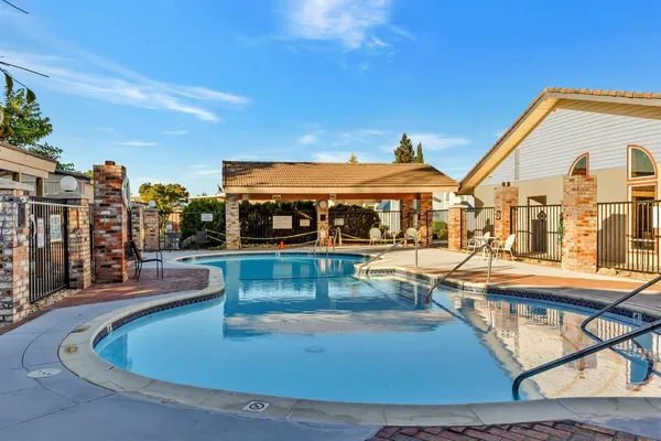 a view of a swimming pool with outdoor seating