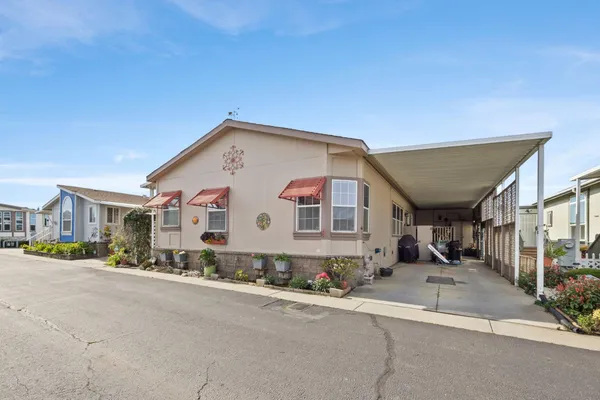 a view of a white house with a street