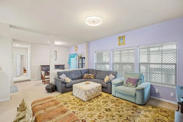 a bedroom with furniture and a large window