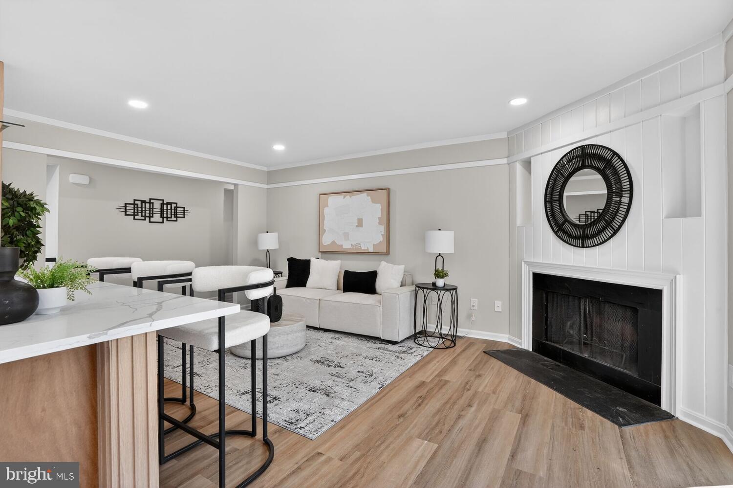 9217 Dorothy Lane Springfield, VA 22153 - Photo 20 of 58 a living room with furniture a clock and a fireplace