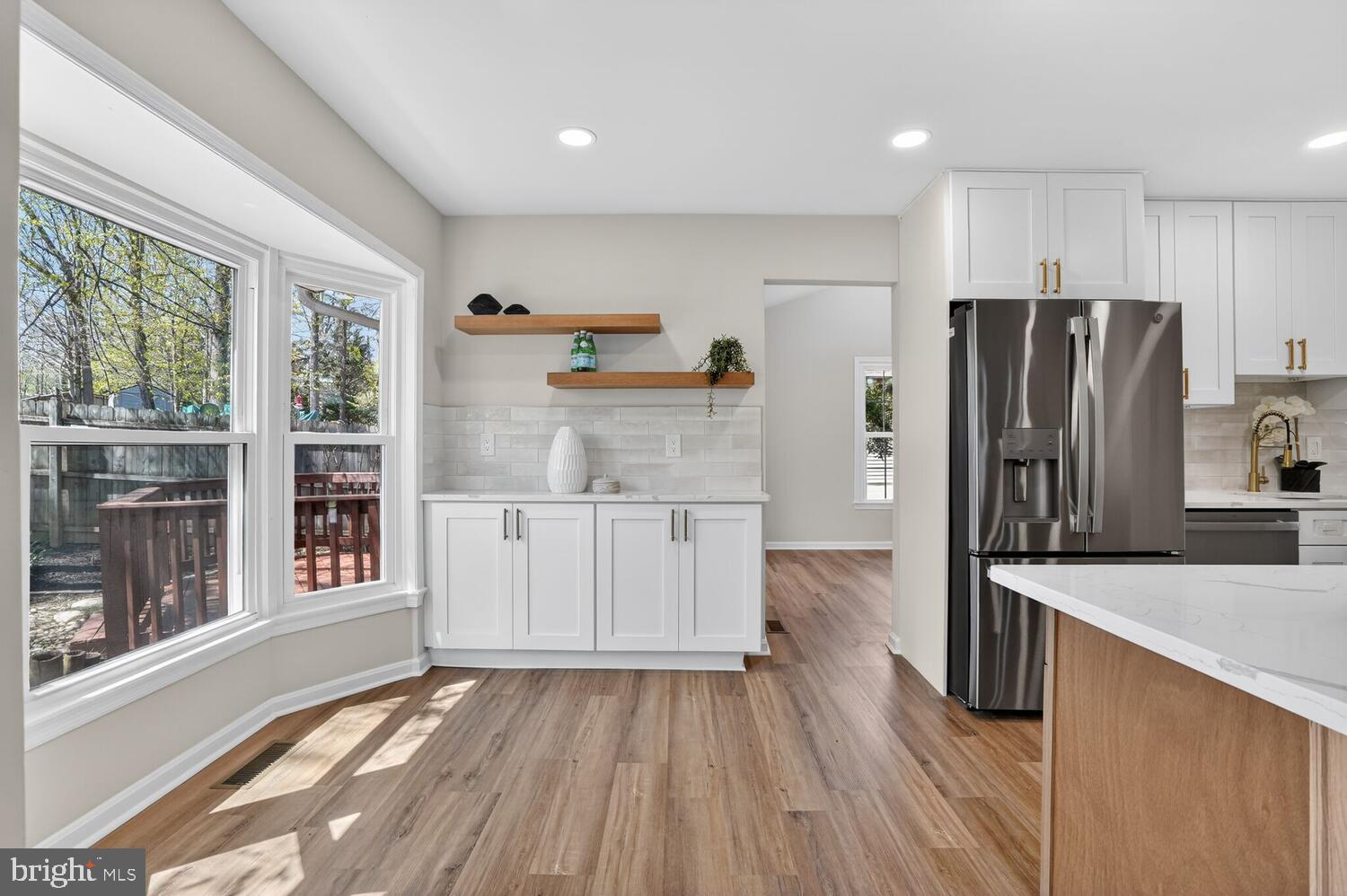 9217 Dorothy Lane Springfield, VA 22153 - Photo 22 of 58 a kitchen with granite countertop a refrigerator and a sink