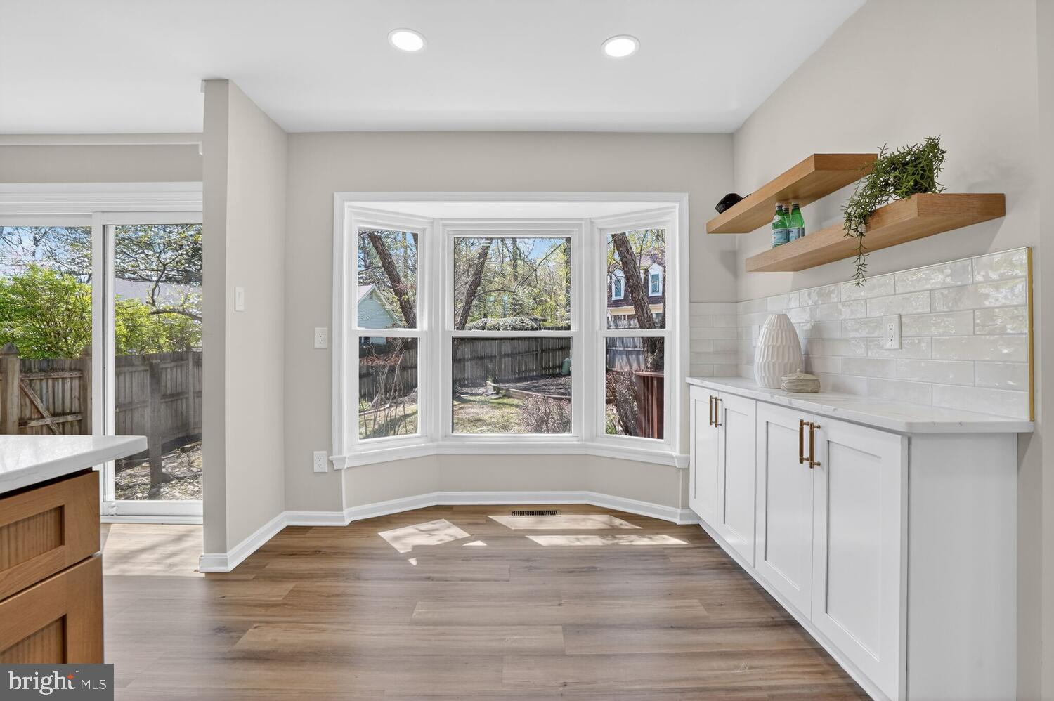 9217 Dorothy Lane Springfield, VA 22153 - Photo 23 of 58 a view of an empty room with wooden floor and a window