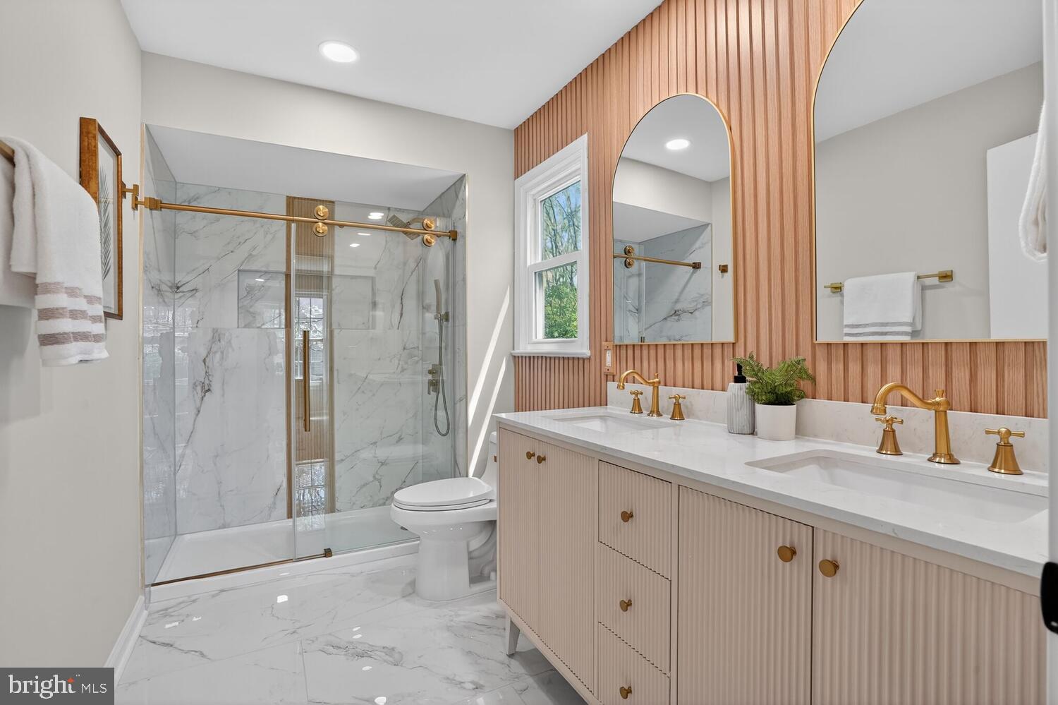 9217 Dorothy Lane Springfield, VA 22153 - Photo 30 of 58 a bathroom with a double vanity sink toilet and shower