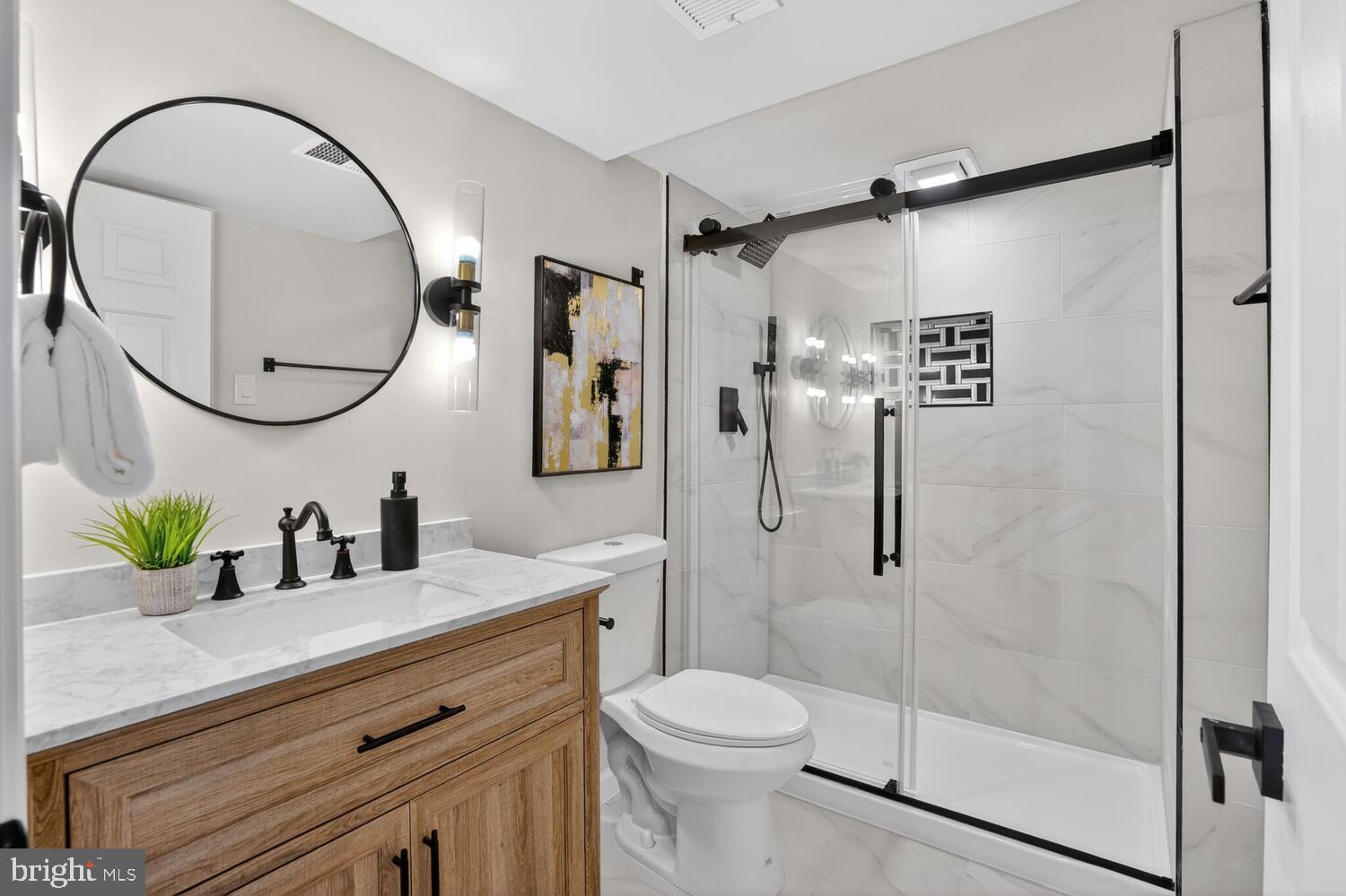 9217 Dorothy Lane Springfield, VA 22153 - Photo 43 of 58 a bathroom with a sink a toilet and a mirror