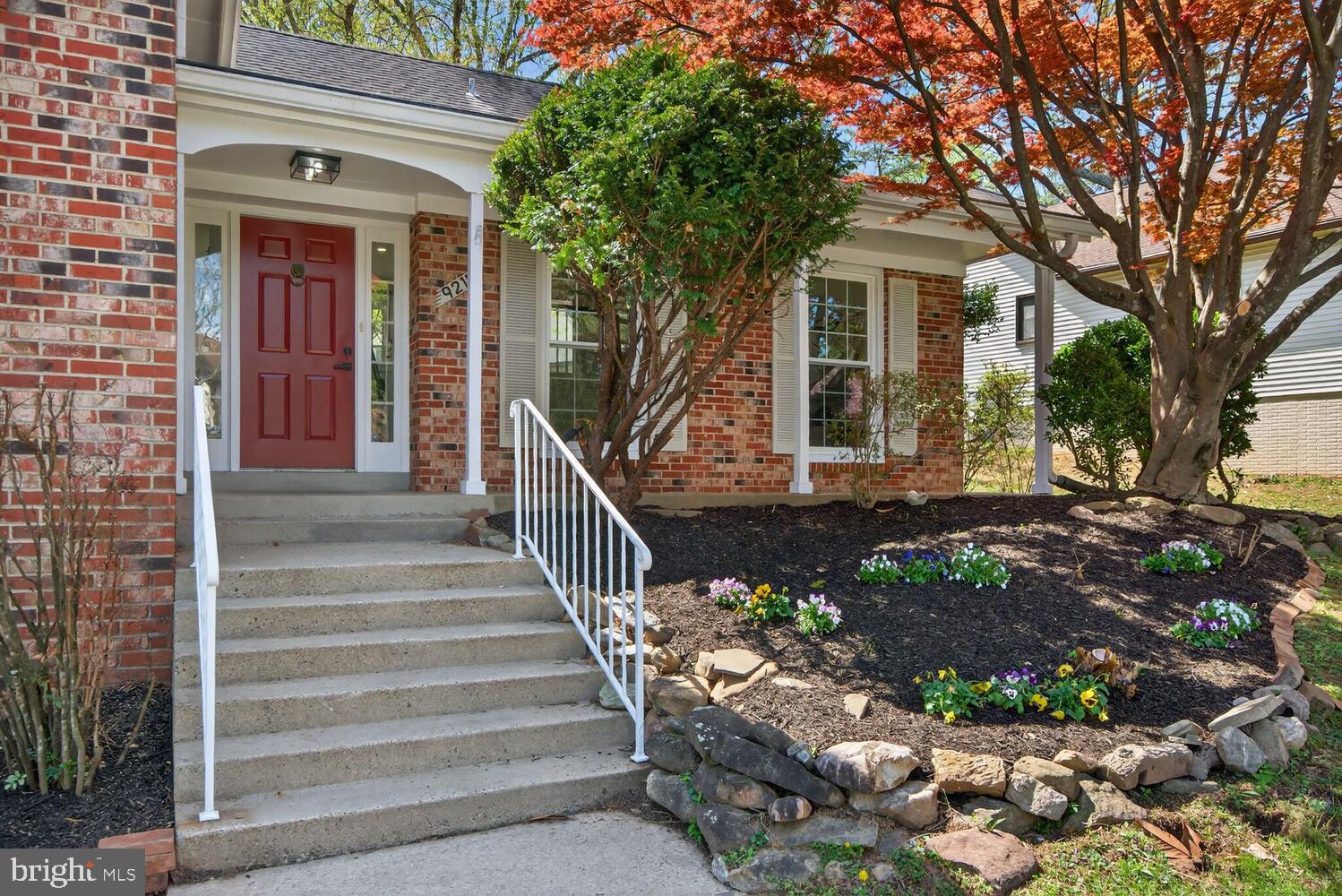9217 Dorothy Lane Springfield, VA 22153 - Photo 46 of 58 a front view of a house with a garden