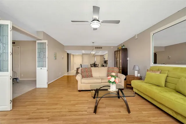 a bedroom with a bed lamps and a large window