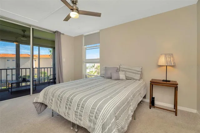 a bedroom with a bed couch and a mirror