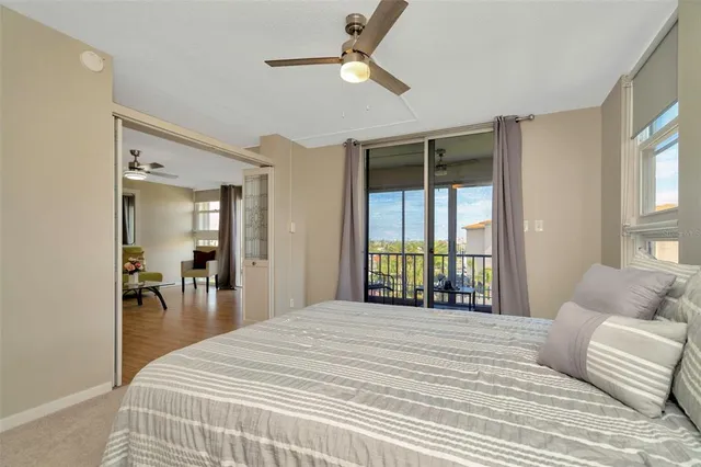 a bedroom with a large bed and a large window