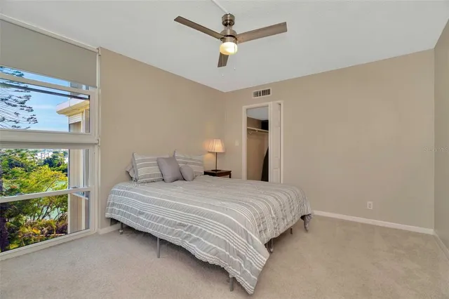 a living room with a floor to ceiling window and wooden floor