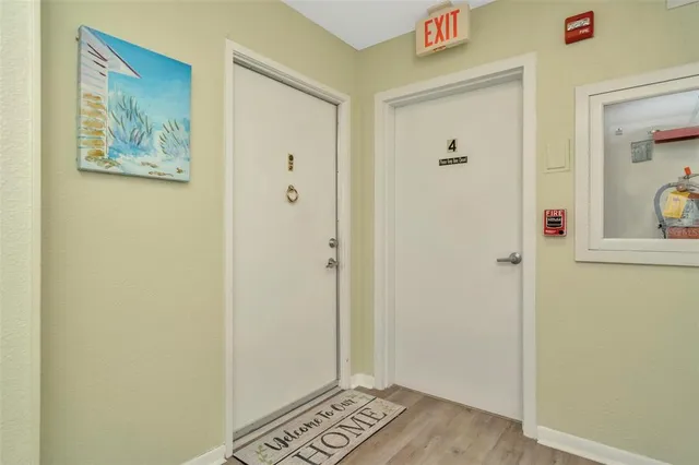 a large white kitchen with lots of counter space a sink appliances and cabinets