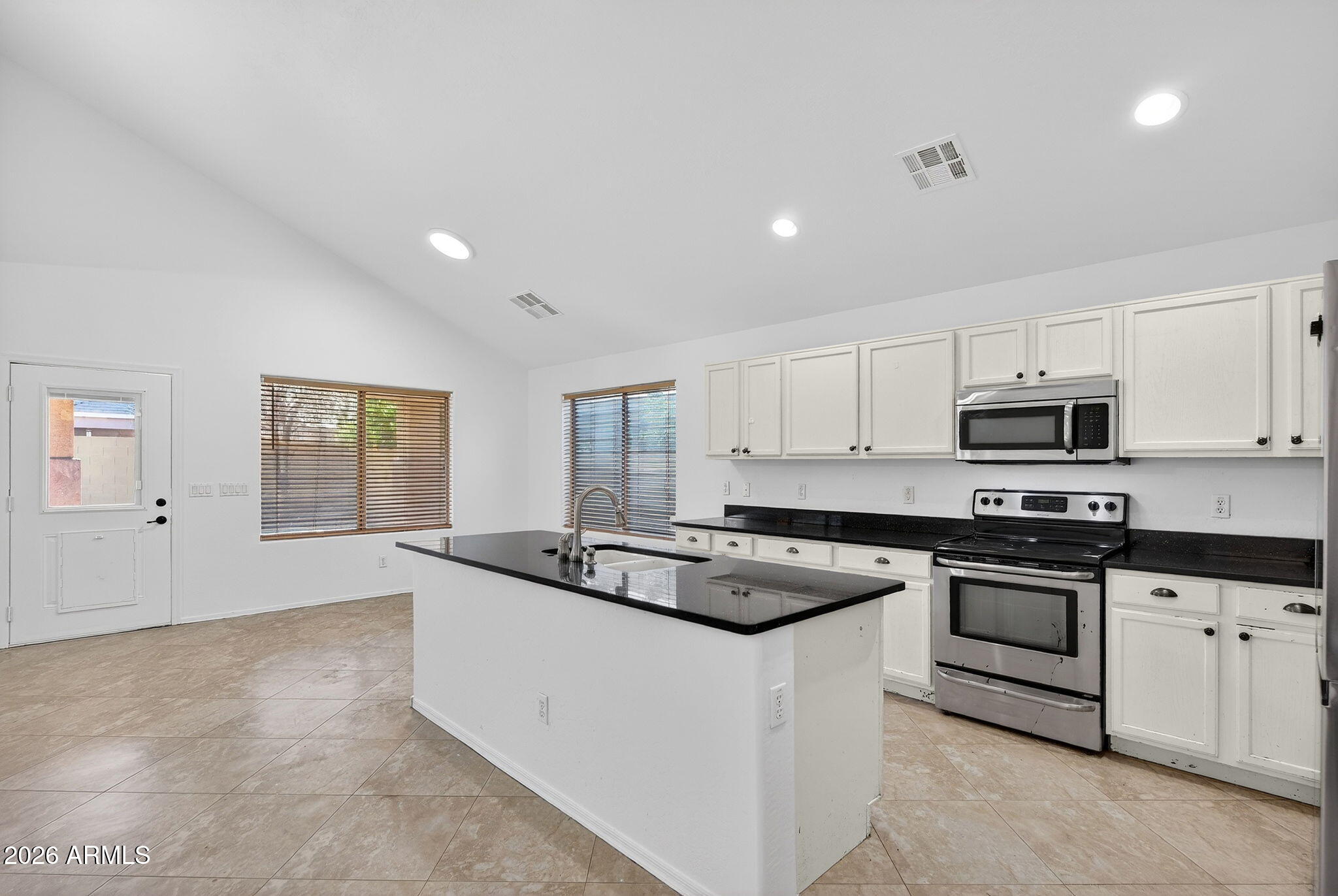 46039 West Amsterdam Road Maricopa, AZ 85139 - Photo 8 of 61 a kitchen that has a sink and a stove top oven