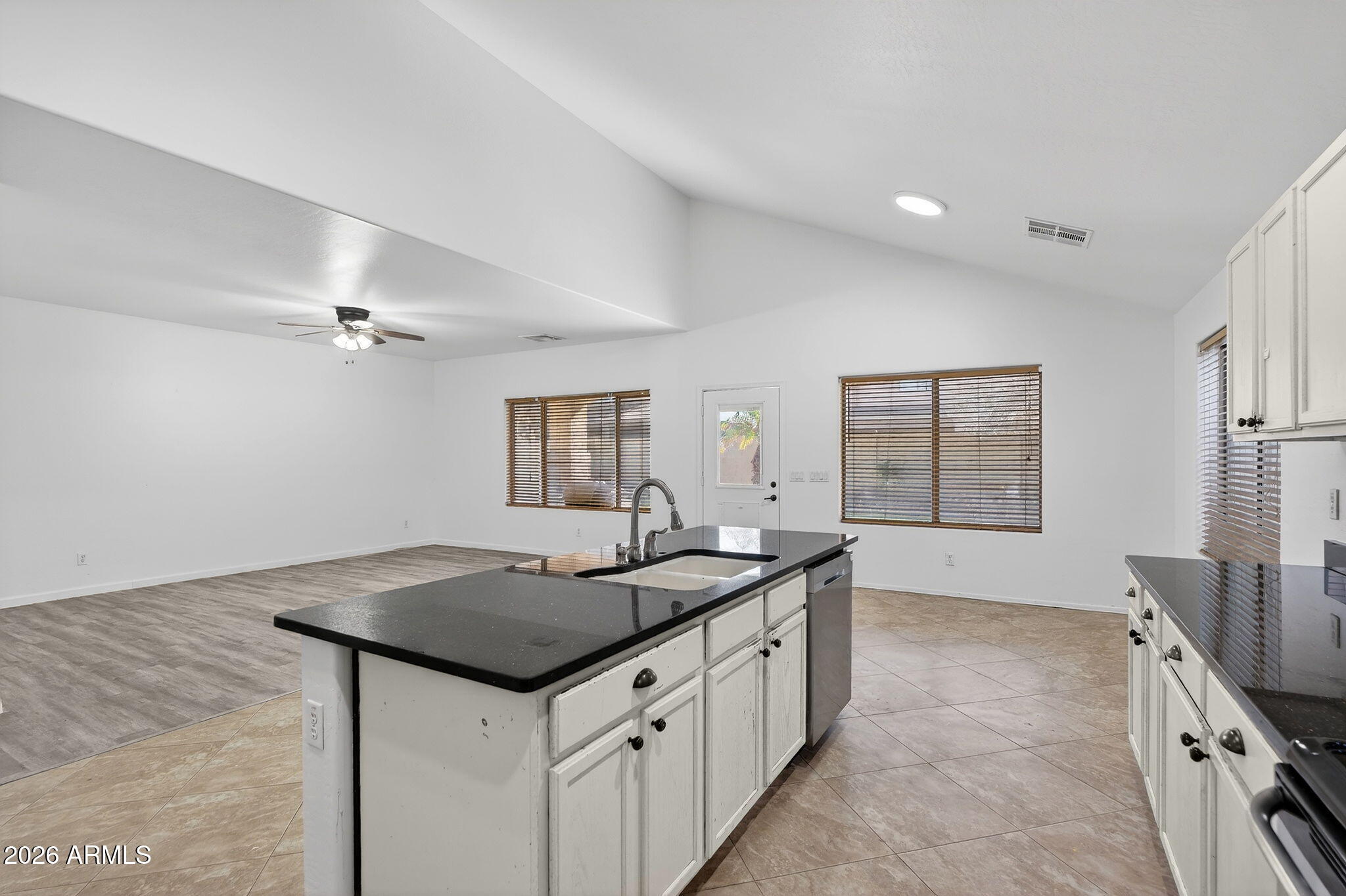 46039 West Amsterdam Road Maricopa, AZ 85139 - Photo 12 of 61 a kitchen with granite countertop a sink and a refrigerator