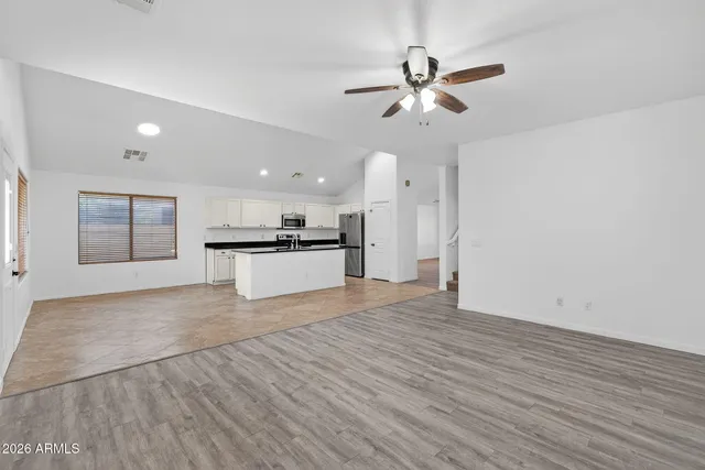 a view of kitchen with granite countertop cabinets and wooden floor