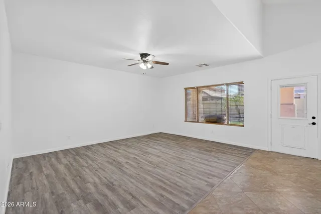 wooden floor in an empty room with a window