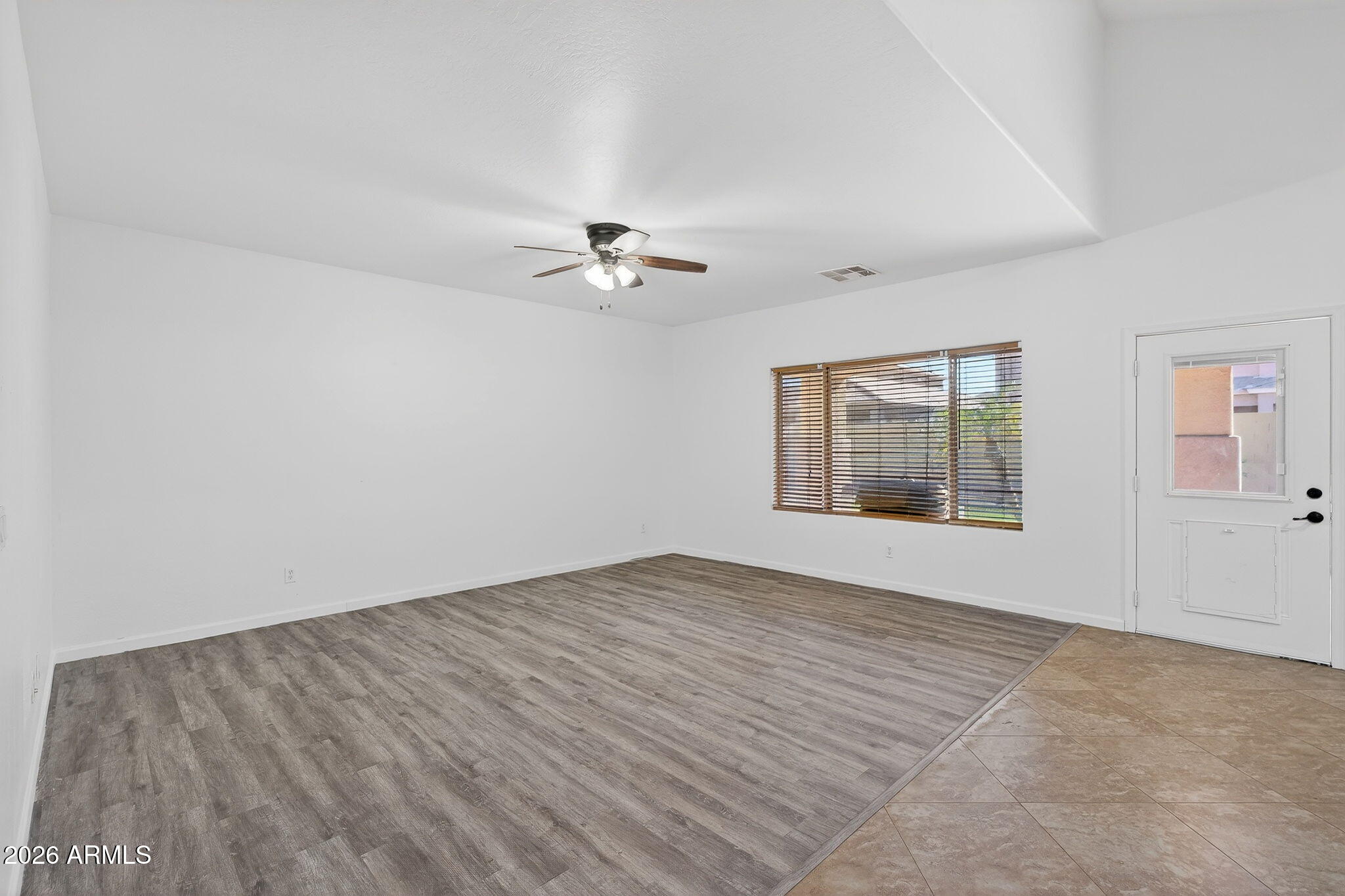 46039 West Amsterdam Road Maricopa, AZ 85139 - Photo 14 of 61 wooden floor in an empty room with a window