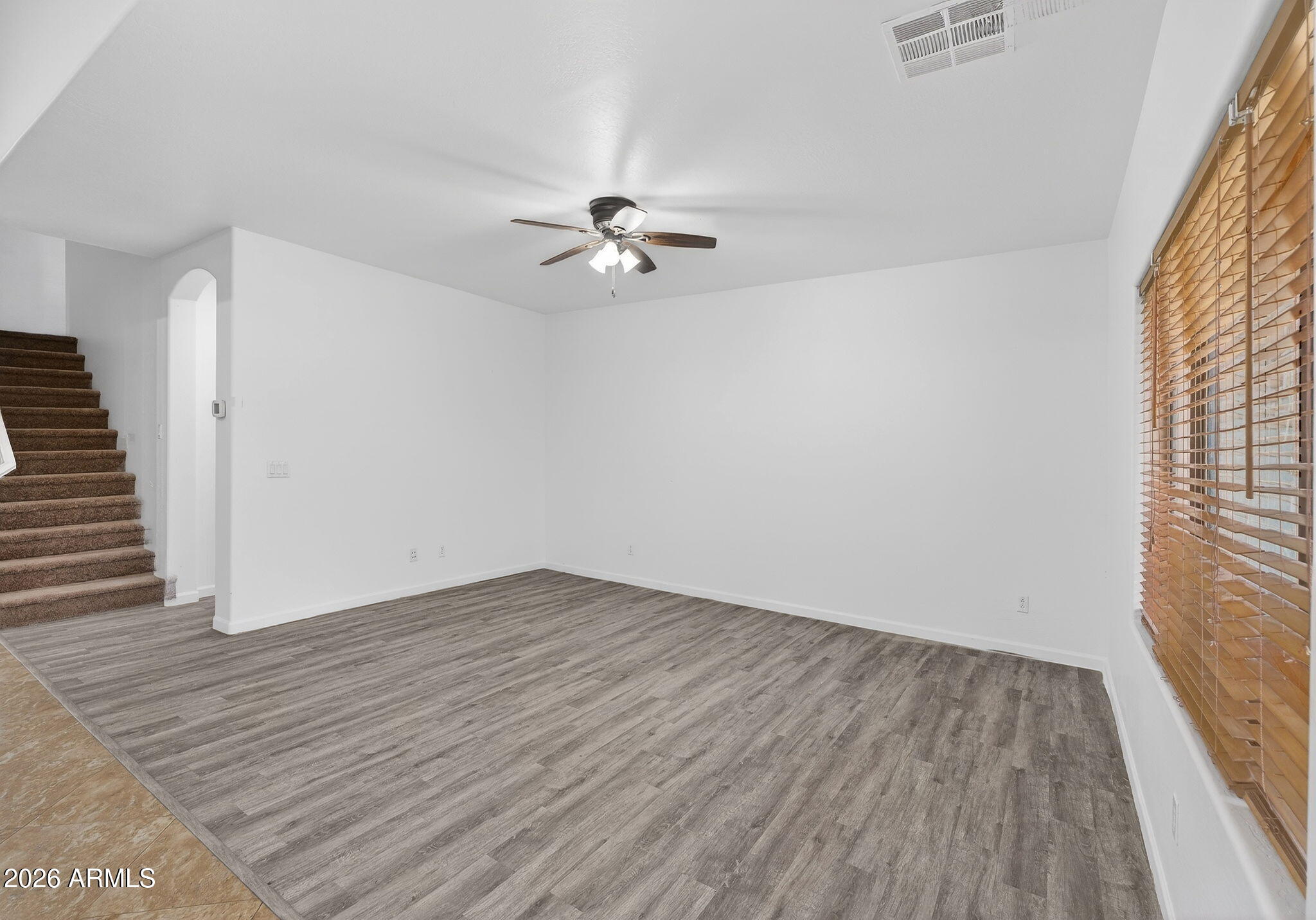 46039 West Amsterdam Road Maricopa, AZ 85139 - Photo 16 of 61 wooden floor in an empty room with a window