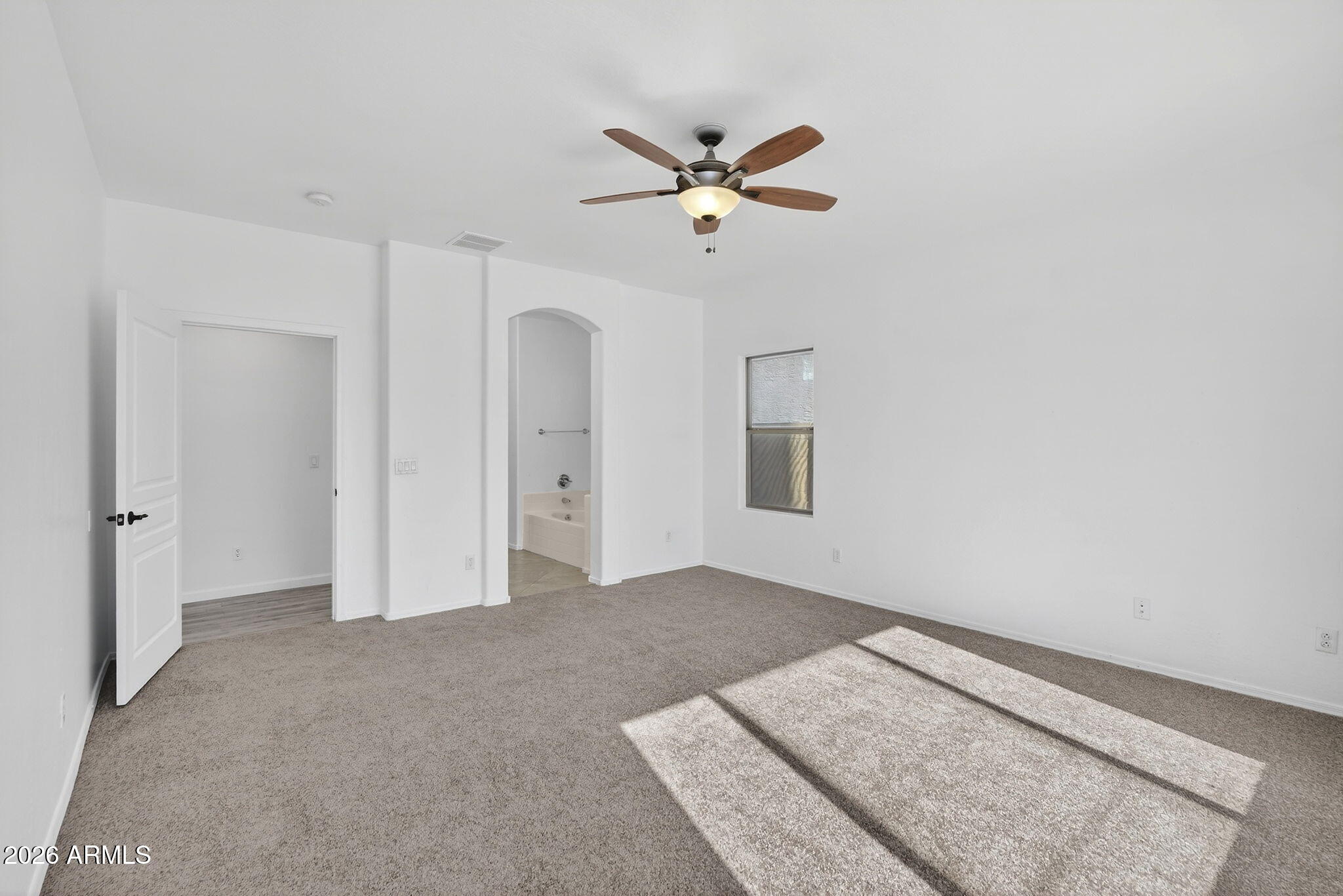 46039 West Amsterdam Road Maricopa, AZ 85139 - Photo 20 of 61 a view of a livingroom with a ceiling fan and entryway
