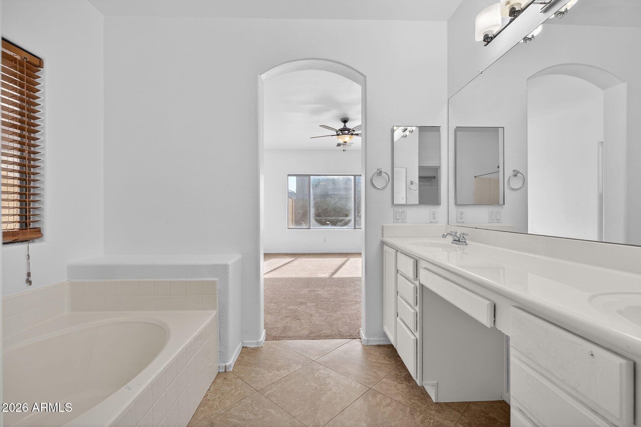 46039 West Amsterdam Road Maricopa, AZ 85139 - Photo 23 of 61 a bathroom with a tub sink and mirror