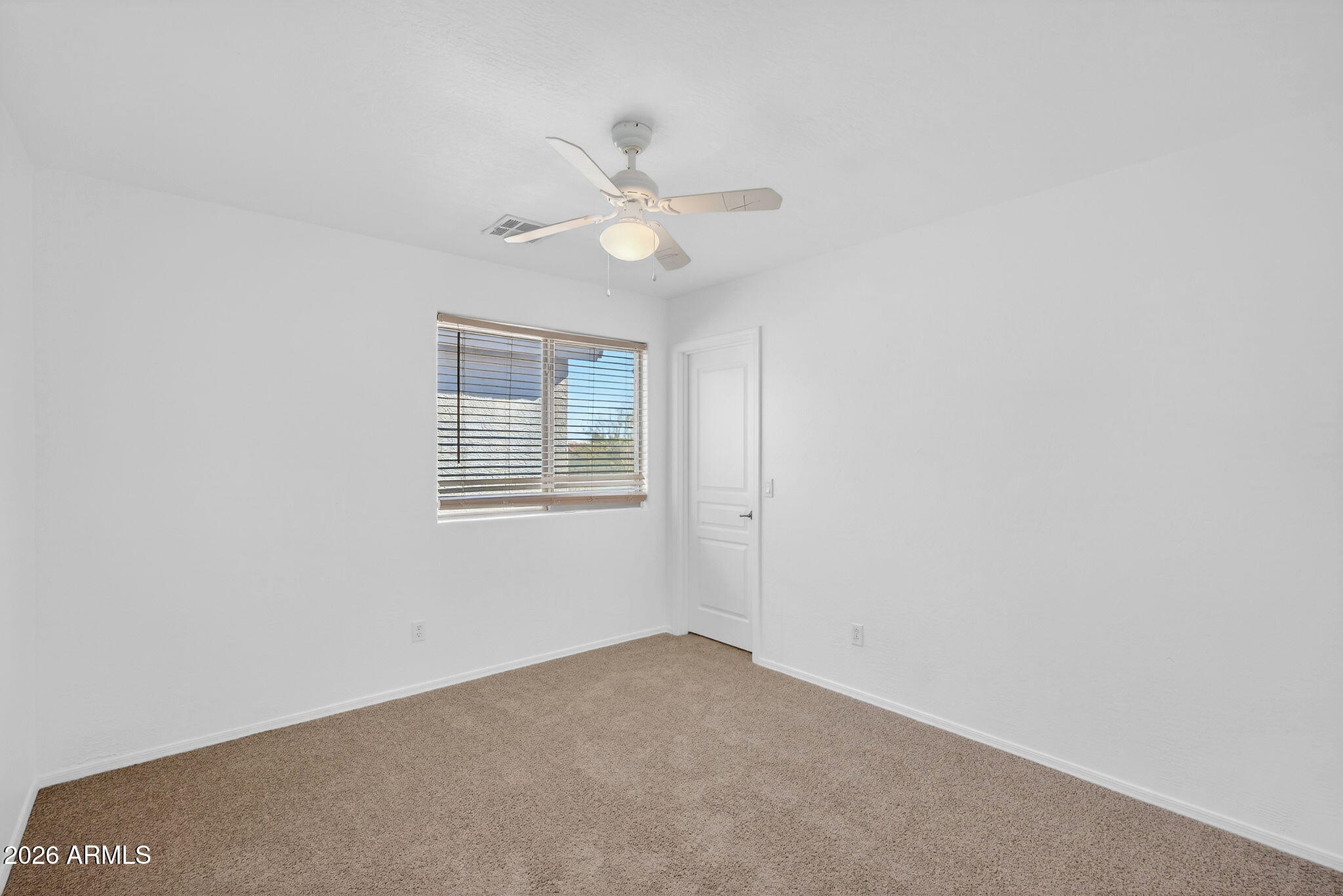 46039 West Amsterdam Road Maricopa, AZ 85139 - Photo 29 of 61 an empty room with a window and ceiling fan