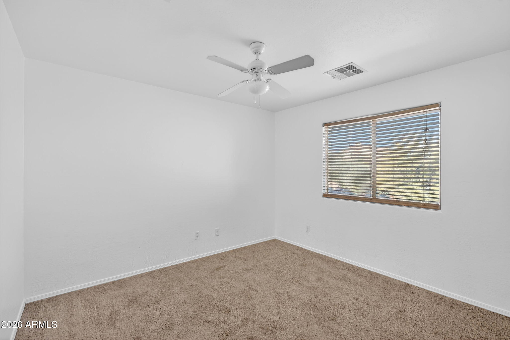 46039 West Amsterdam Road Maricopa, AZ 85139 - Photo 33 of 61 an empty room with a window and a fan