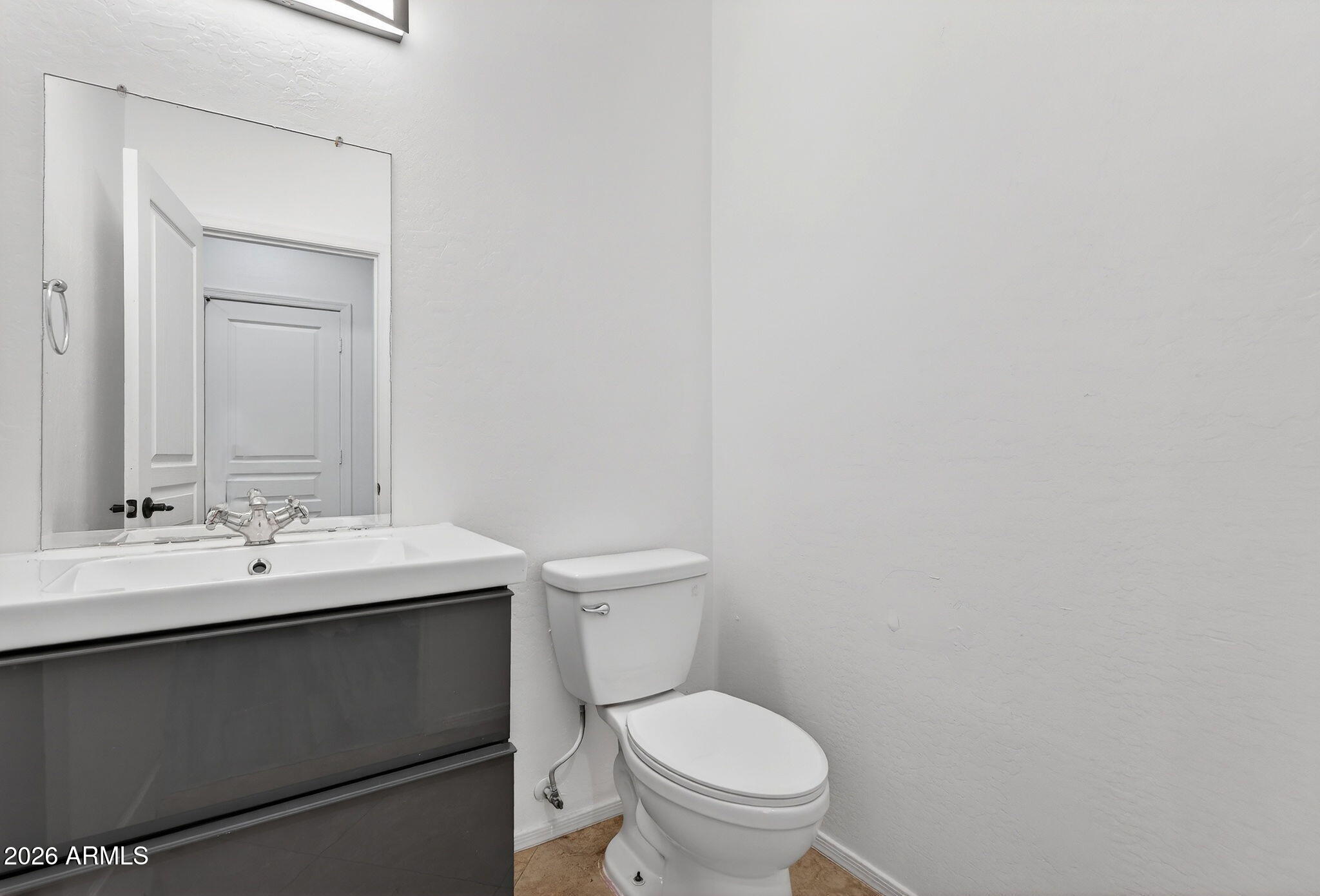 46039 West Amsterdam Road Maricopa, AZ 85139 - Photo 40 of 61 a bathroom with a toilet a sink and mirror