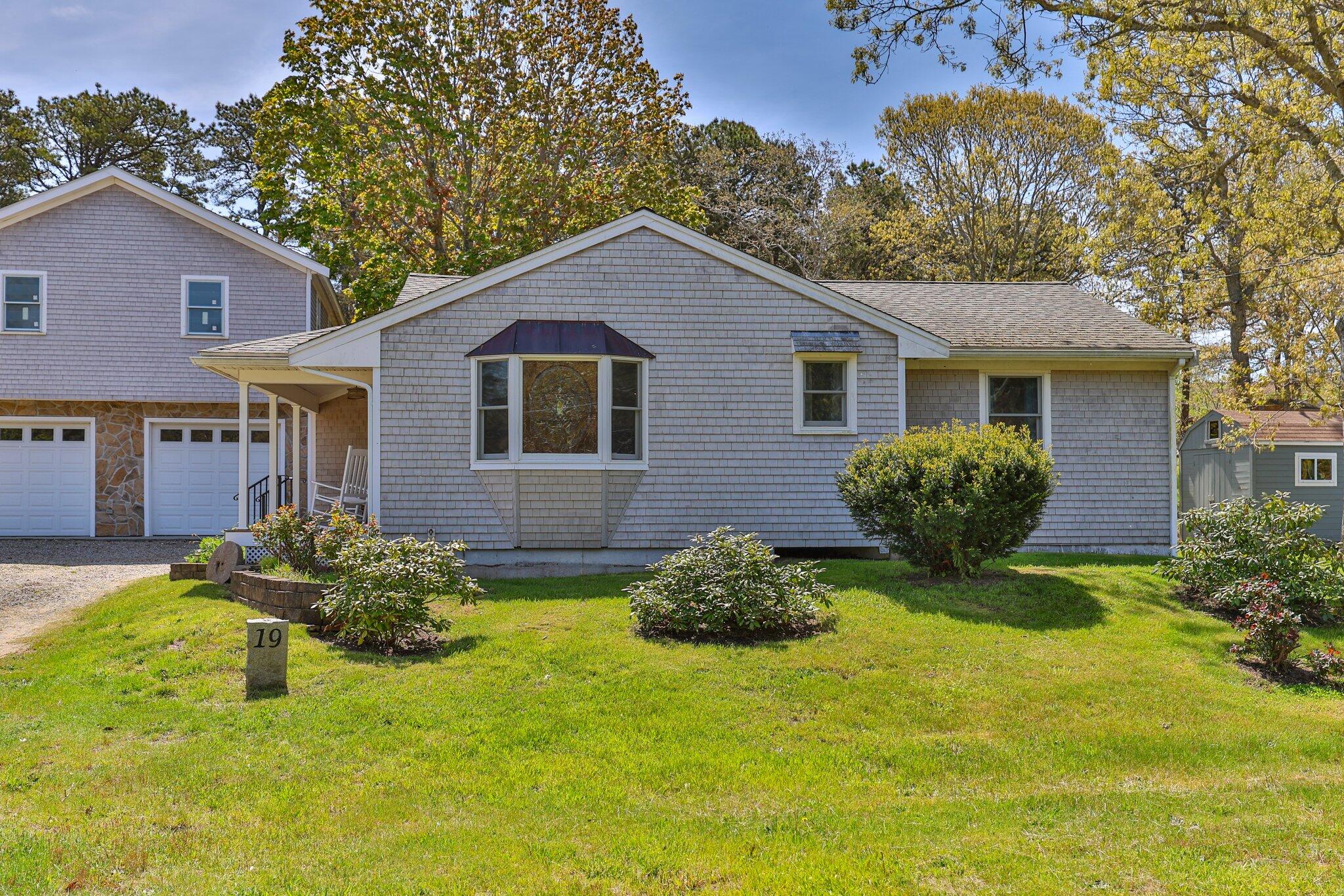 19 South Highland Road Truro, MA 02666 - Photo 2 of 45 a view of a yard in front of a house with plants and large tree