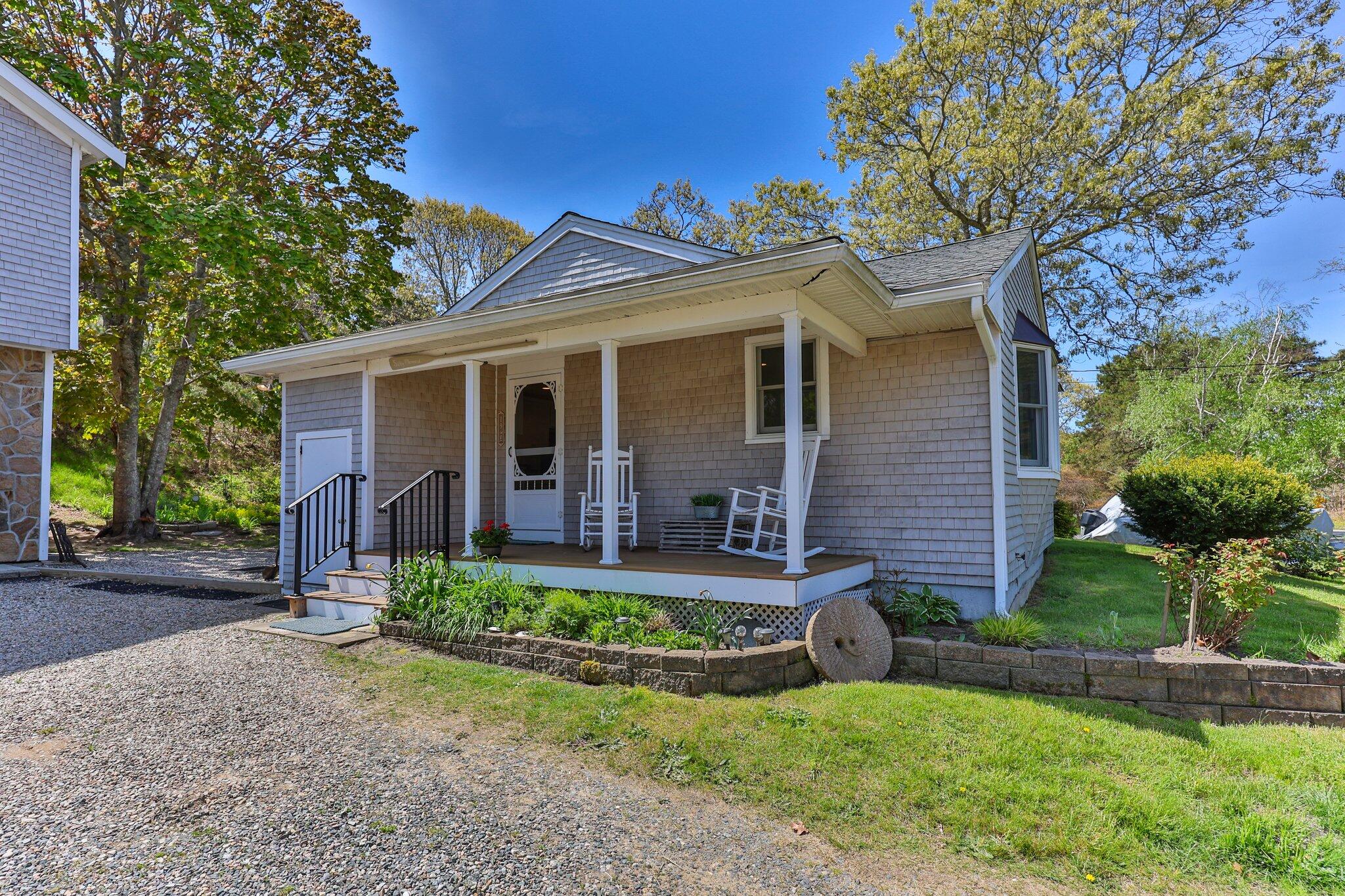19 South Highland Road Truro, MA 02666 - Photo 3 of 45 a front view of a house with a yard table and chairs