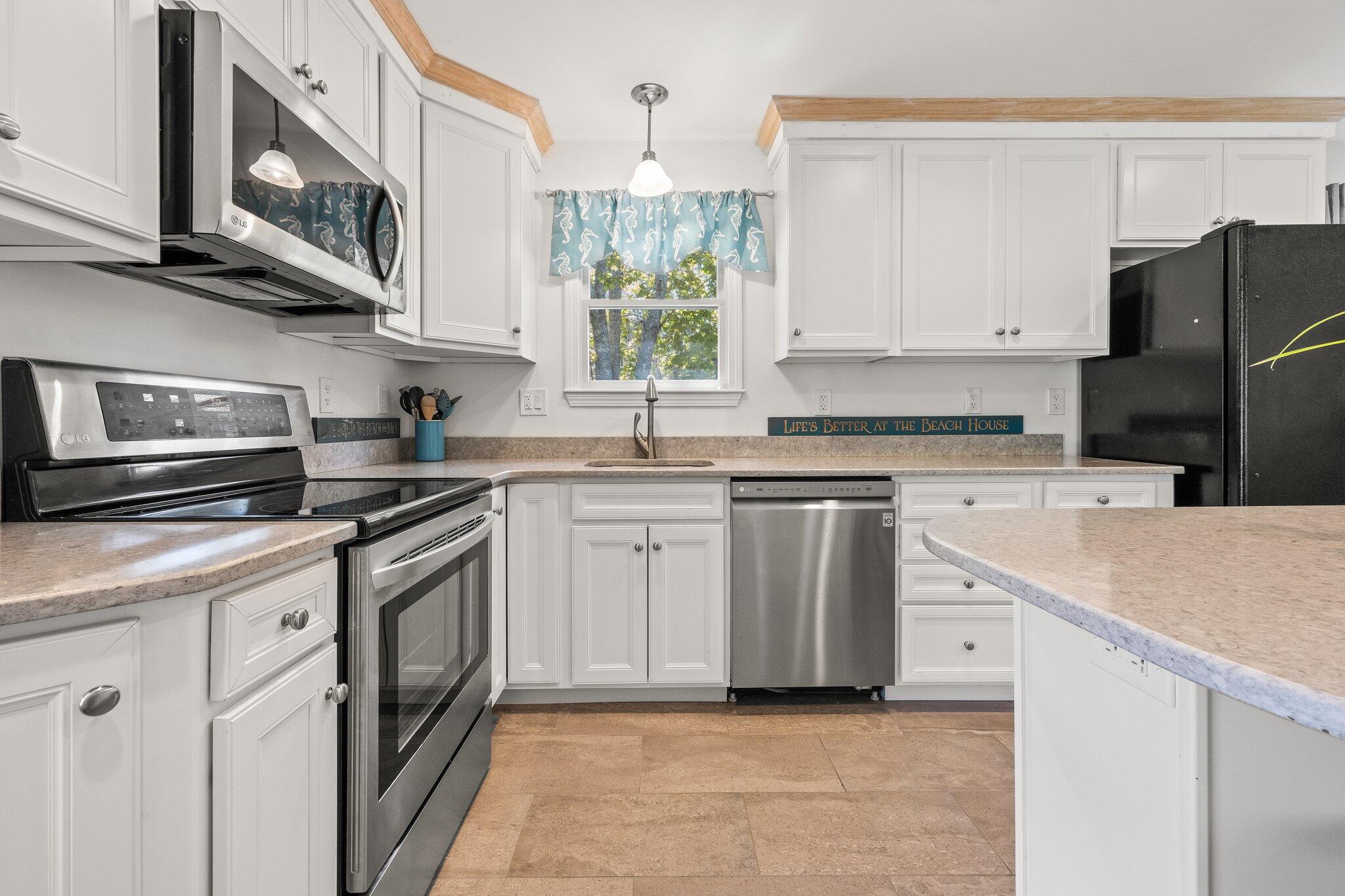 19 South Highland Road Truro, MA 02666 - Photo 8 of 45 a kitchen with stainless steel appliances granite countertop a sink stove and refrigerator