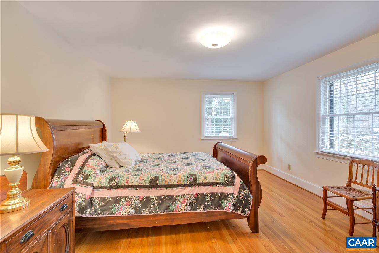 1442 Grove Road Charlottesville, VA 22901 - Photo 21 of 31 a bedroom with a bed and wooden floor
