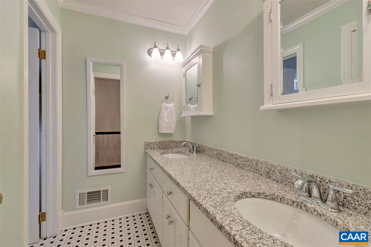 1442 Grove Road Charlottesville, VA 22901 - Photo 23 of 31 a bathroom with a granite countertop sink a mirror a vanity and shower