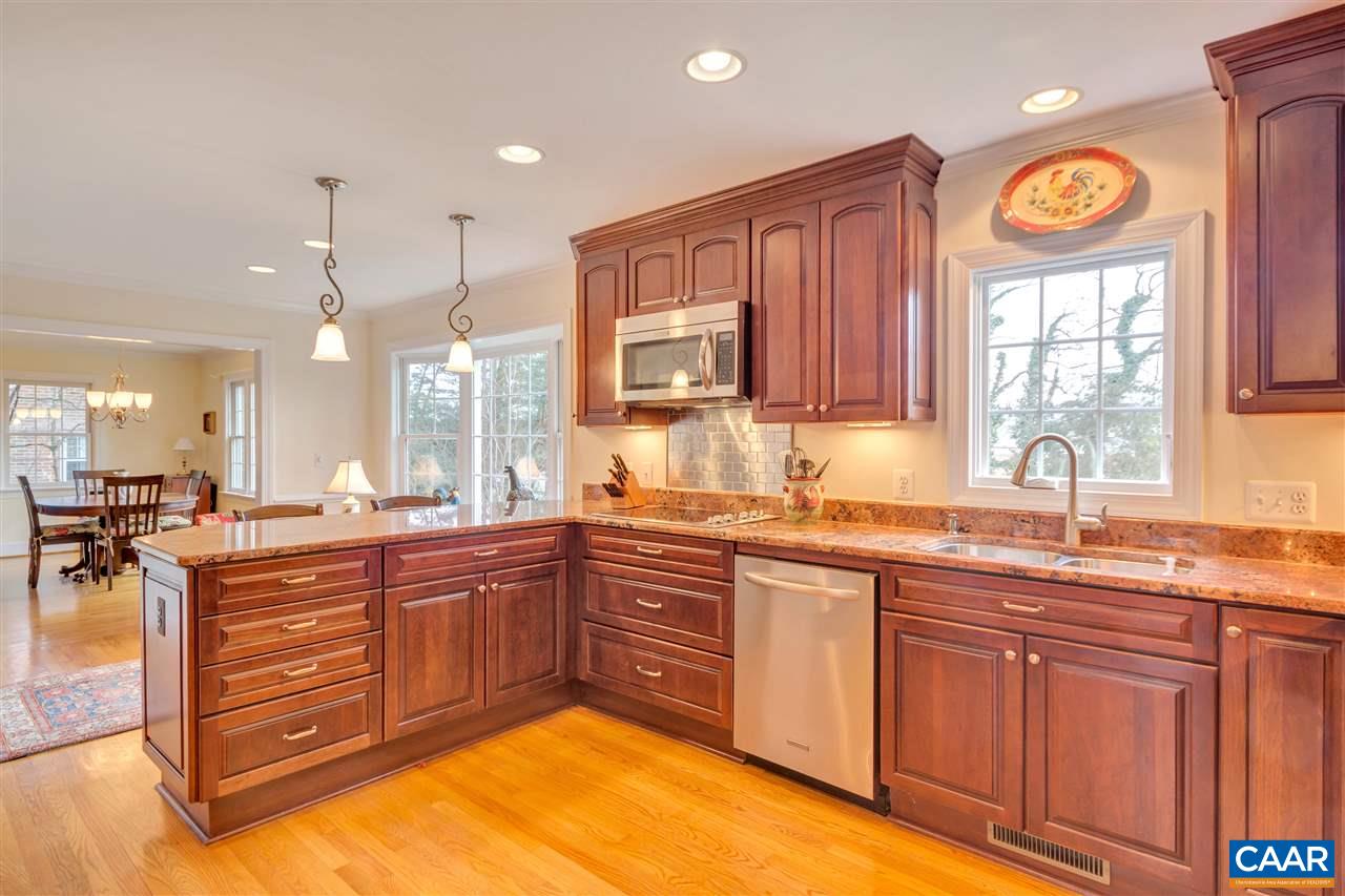 1442 Grove Road Charlottesville, VA 22901 - Photo 3 of 31 a large kitchen with cabinets chairs and a sink