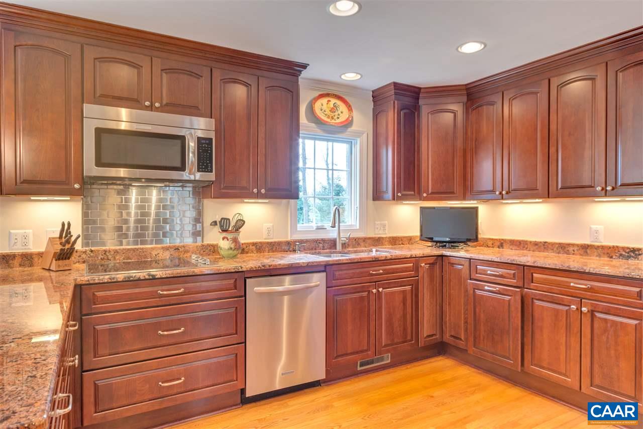 1442 Grove Road Charlottesville, VA 22901 - Photo 4 of 31 a kitchen with cabinets a window and appliances