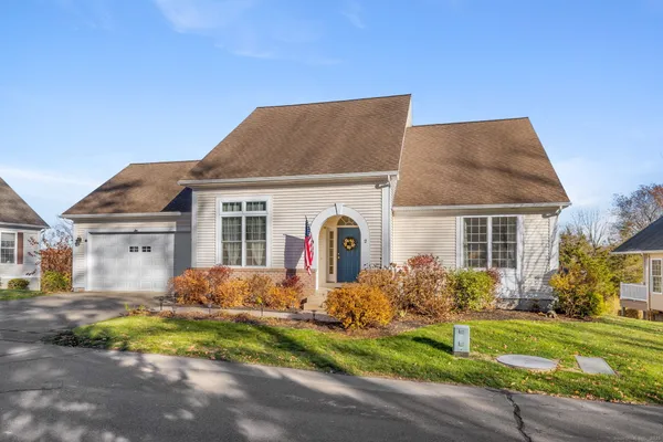 a front view of house with yard and green space