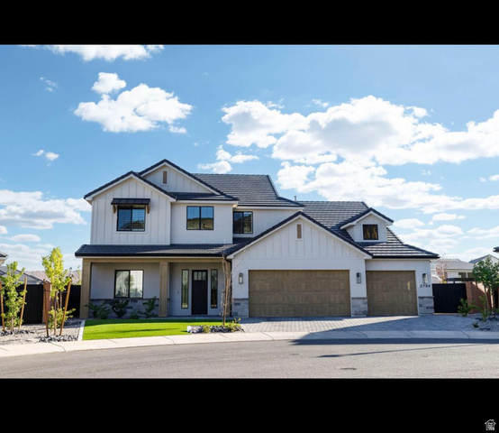 2788 East Rill Drive Washington, UT 84780 - Photo 1 of 41 Contemporary exterior featuring a black tiled roof, board and batten siding, stucco finishes, stone accents, and two wood-finish garage doors