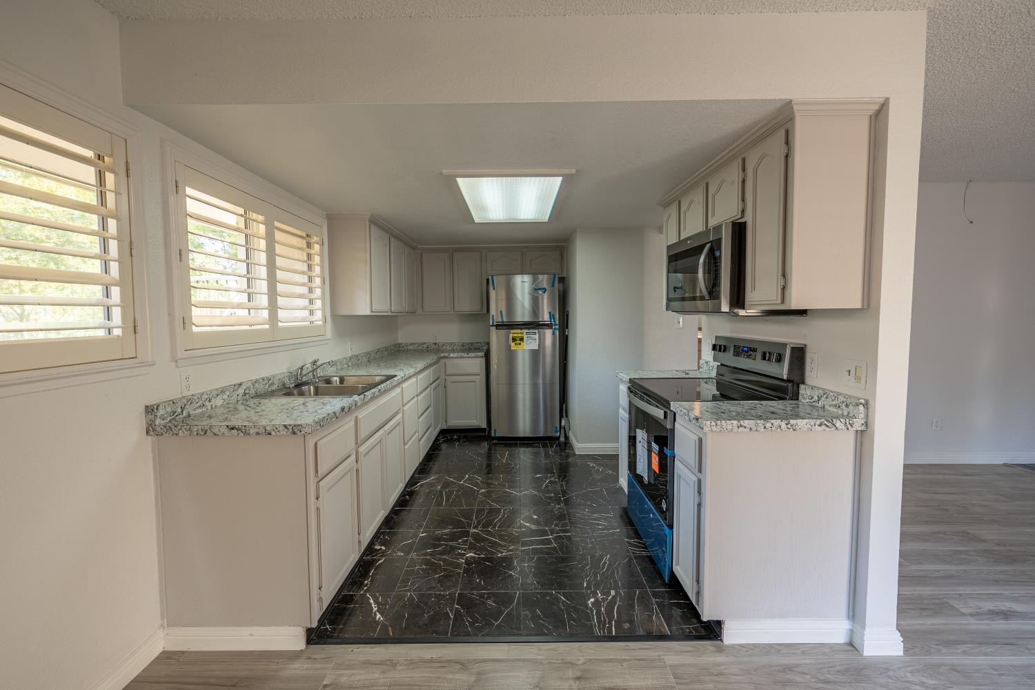 3700 Tully Road, Unit 5 Modesto, CA 95356 - Photo 8 of 38 a kitchen with a sink stove top oven and refrigerator