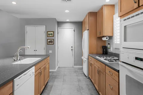 a kitchen with stainless steel appliances a sink stove and cabinets