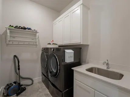 a utility room with sink dryer and washer