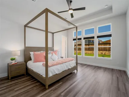 a bedroom with a large bed and a window