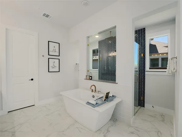 a bathroom with a bathtub and shower