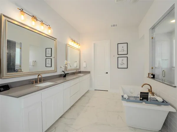 a bathroom with double vanity sinks and a mirror