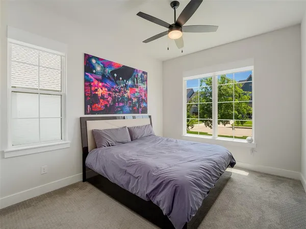 a bedroom with a large bed and a window